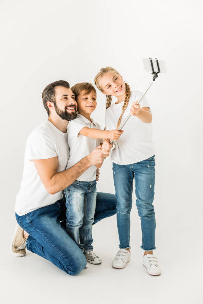 istock father with children taking selfie 910118860