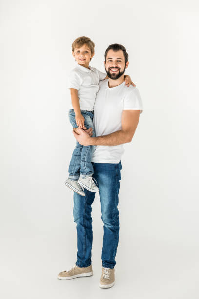 happy father and son together happy father holding adorable little son and smiling at camera isolated on white father holding son stock pictures, royalty-free photos & images