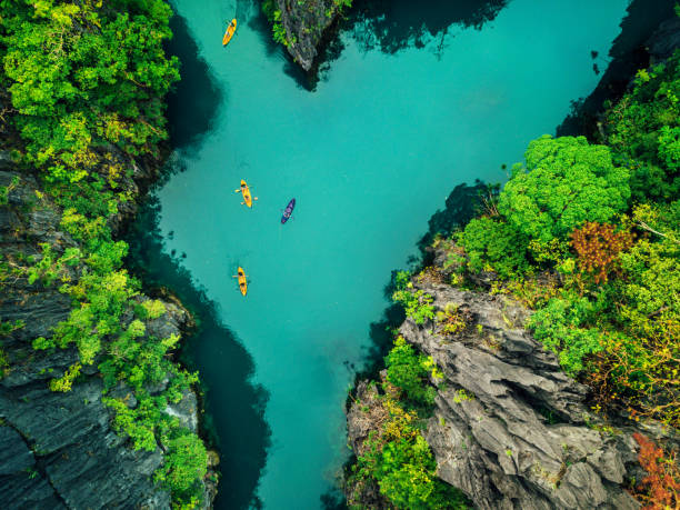 Aerial View of Beautiful Lagoon with Kayaks Aerial View of Beautiful Lagoon with Kayaks philippines landscape stock pictures, royalty-free photos & images