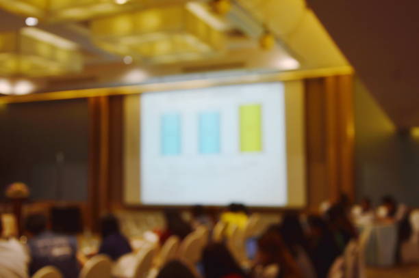 istock blur of projector screen in meeting room 910128002