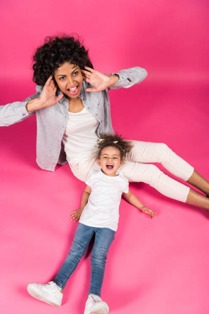 istock Mother and daughter screaming and sitting on floor 910128022