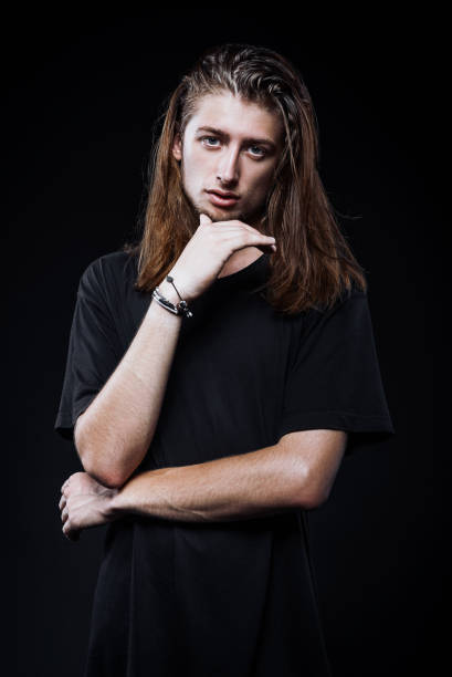 istock Studio portrait of handsome long-haired young man 910131828