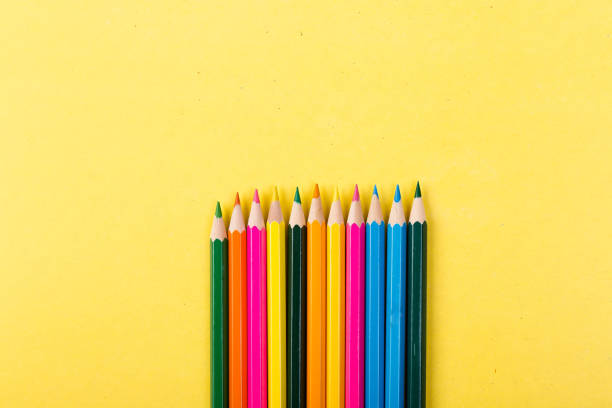 istock Colorful pencils on yellow background. 910139260