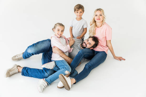 istock family with two kids smiling at camera isolated on white 910142416