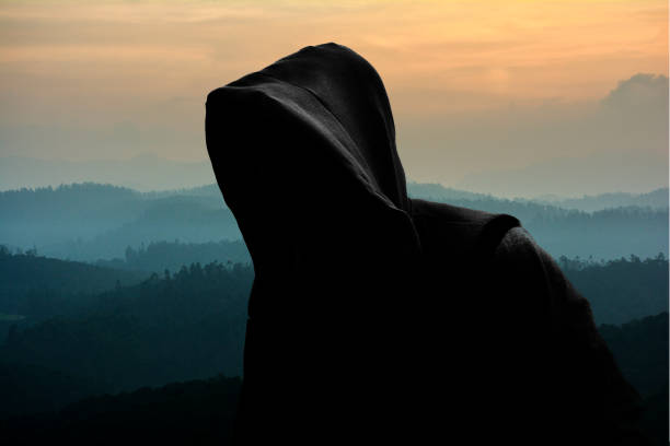 istock Hooded man on nature background 910143338