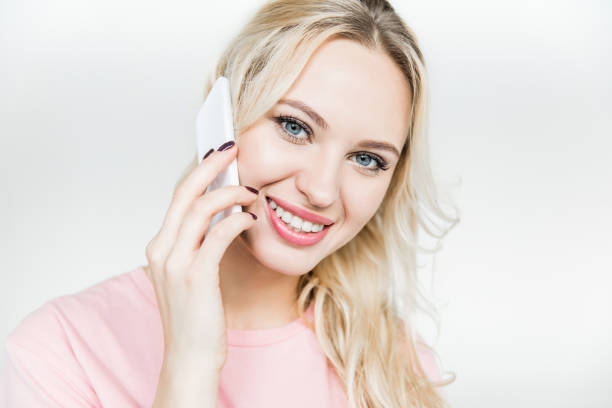 istock young woman talking on smartphone 910144718