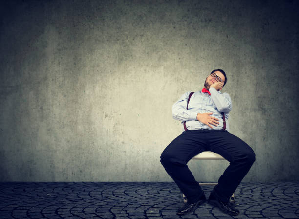 istock Daydreaming obese man being lazy 910144892