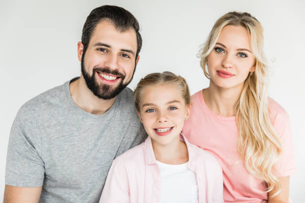 istock family with one kid smiling at camera 910147578