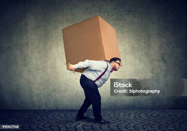 Man Carrying Heavy Box On Back Stock Photo - Download Image Now - Over-Burdened, Carrying, Heavy