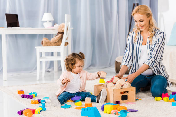 istock happy pregnant mother playing with small daughter 910148068