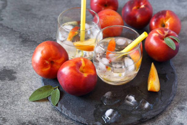 istock Summer diet cold drink: water with nectarine and ice, two glasses 910148178