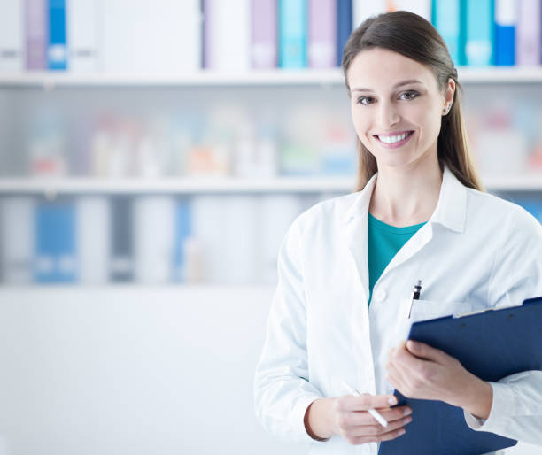 istock Smiling female doctor holding a clipboard 910148602