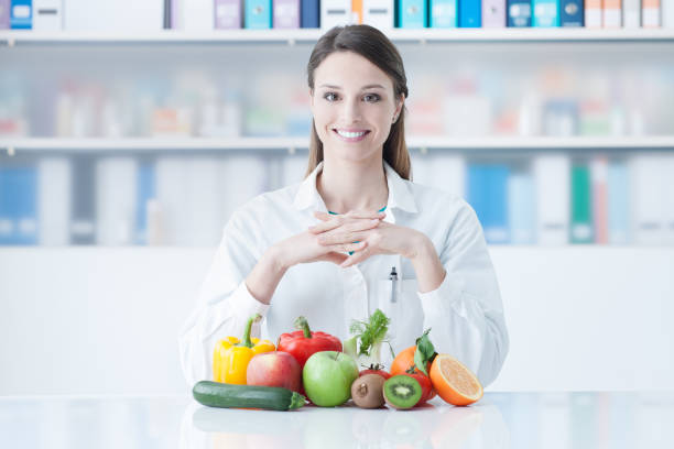 istock Smiling dietician with healthy vegetables 910148680