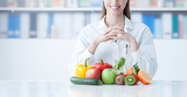 istock Smiling dietician with healthy vegetables 910148714