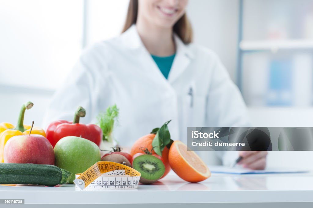 Diet and weight loss Nutritionist desk with healthy fruit, vegetables and a measuring tape, weight loss and diet concept Nutritionist Stock Photo