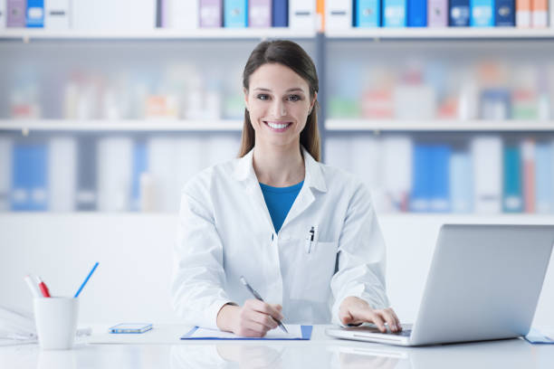 istock Female doctor working at office desk 910148822