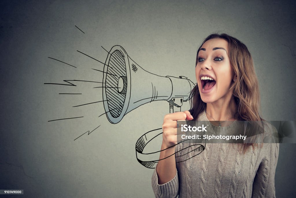 Cheerful woman sharing with news using loudspeaker Content young woman screaming in loudspeaker making announcement. Communication Stock Photo