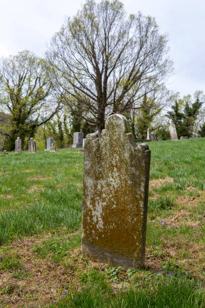 istock Very old grave headstone on a hill with graveyard in the background 910152006