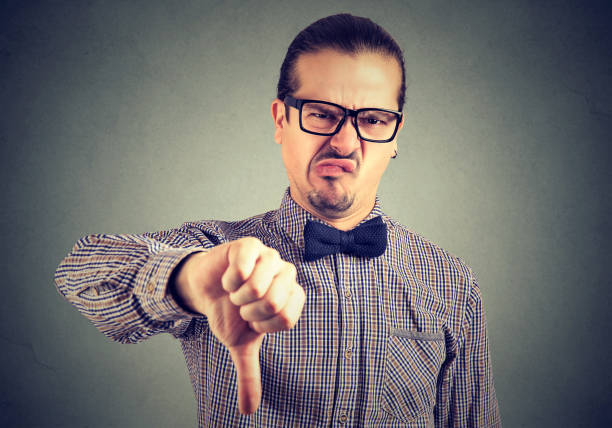 istock Man showing thumb down in disgust 910154624
