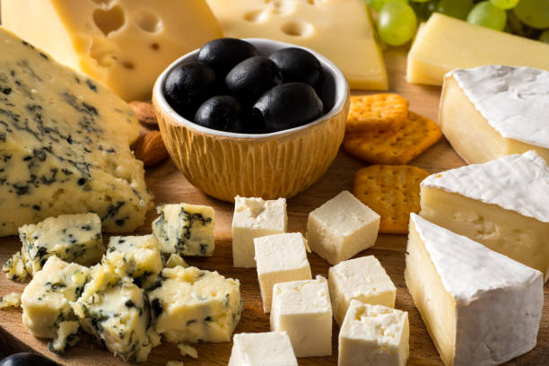 istock Various types of cheese on wooden cutting board. 910155060