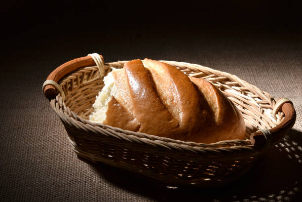 istock Half a loaf of white bread in a wicker basket 910158722