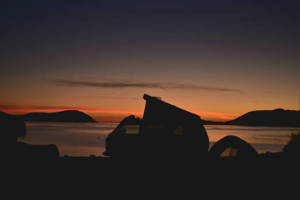 istock sunrise camping tent silhouette pop-up camper van beach 910158960