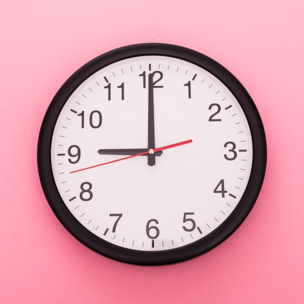 istock Big wall clock isolated on rose background. Nine o'clock. 910159326