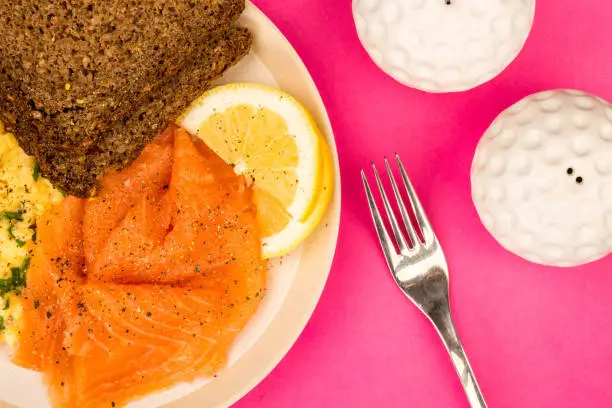 Photo of Smoked Salmon and Scrambled Eggs With Rye Bread and Lemon Scandinavian Style Breakfast