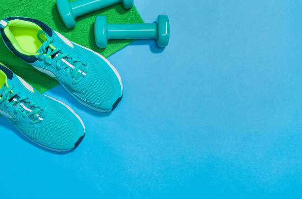 Fitness accessories on blue background mock up, top view