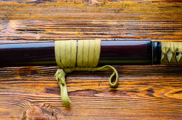 istock Japanese sword katana on wooden background 910165680