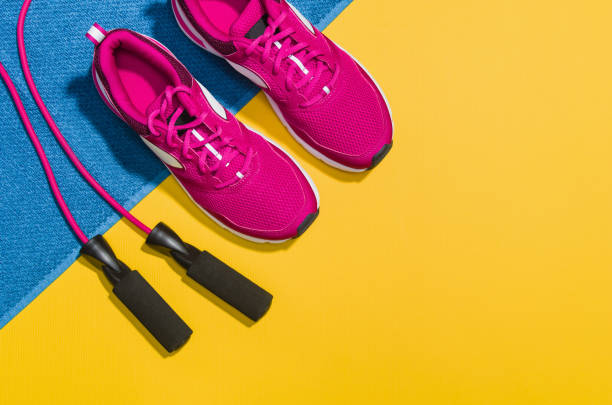istock Fitness accessories on yellow background mock up, top view 910165704
