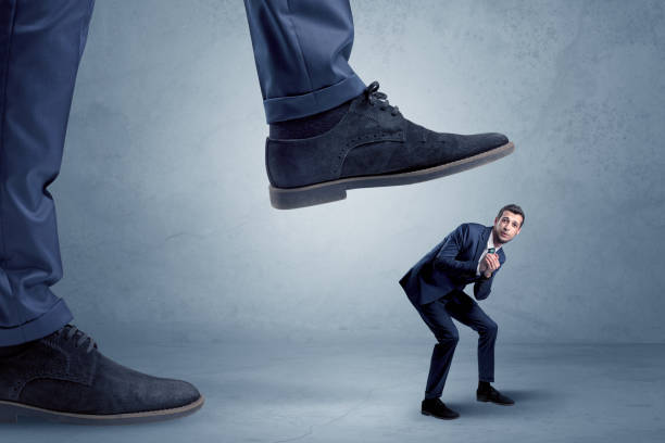 istock Trampled small businessman in suit 910165752