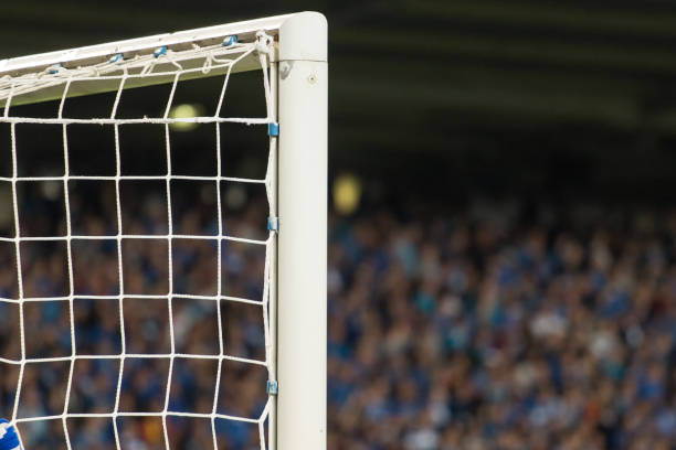 istock Goal post with soccer fans in the background 910166306