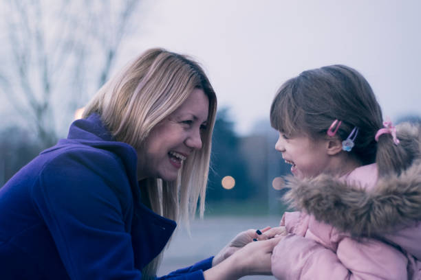 istock Mother and daughter smiling together at dusk 910166378