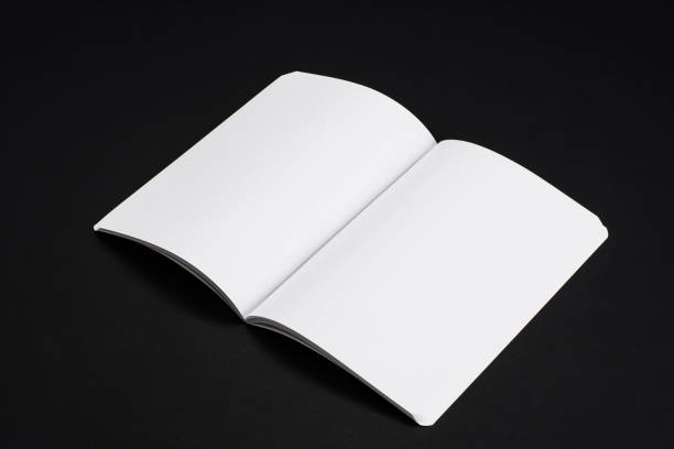 istock Mock-up magazines, book or catalog on black table background 910169544
