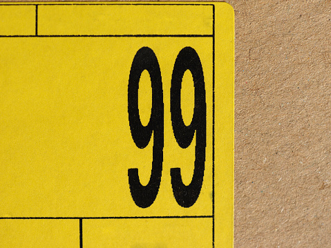 number 99 (ninety nine) printed in black on a yellow label
