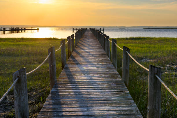 Wooden Dock and Ocean at Sunset stock photo