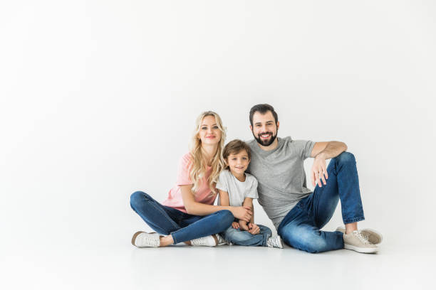 istock little son sitting together isolated on white 910174944