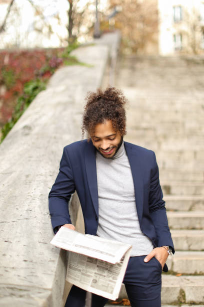 istock Arabian student reading public press in open air 910192840
