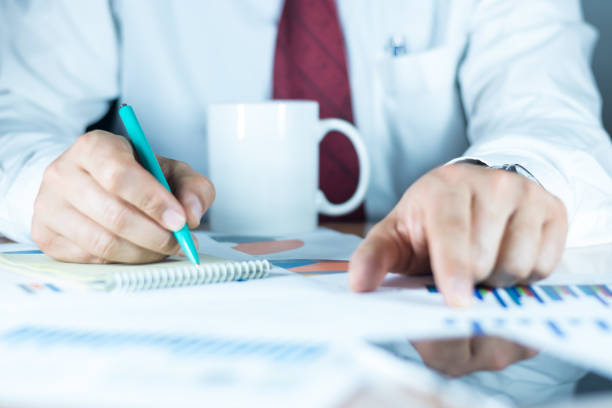istock Businessman checking financial reports on table 910196886