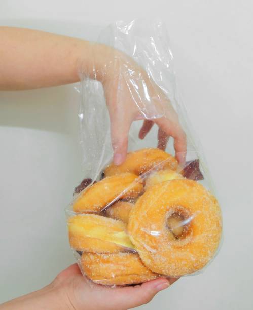 istock Hand Holding A Bag of Donuts with Sugar 910200152