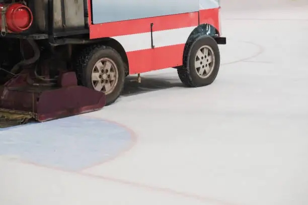 Resurfacer levels ice at hockey rink, special machine