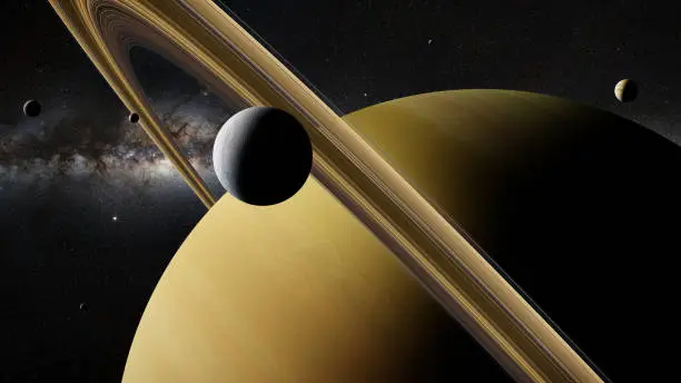 Photo of Saturn moon Enceladus in front of planet Saturn, rings and other moons