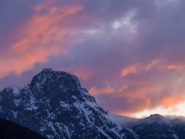 istock Mountain peak orange pink sunset clouds 910215150