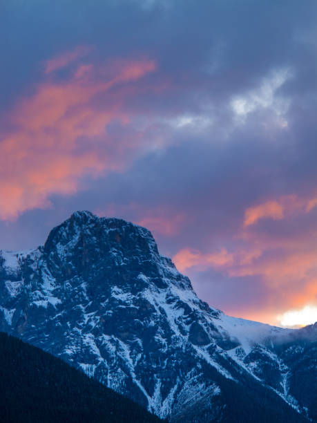 istock Mountain peak orange pink sunset clouds 910215186
