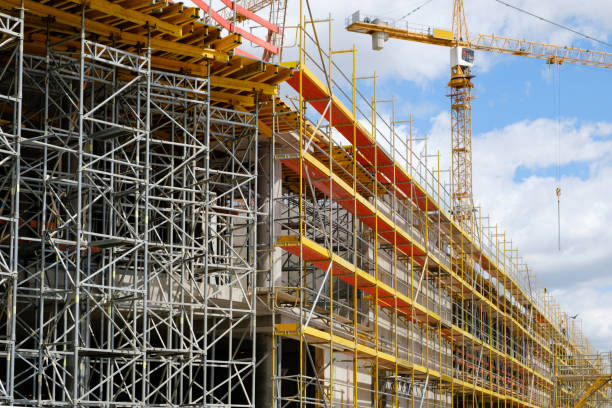 new building construction site,  scaffolding and crane on building site new building construction site - scaffolding and crane on building site scaffolding stock pictures, royalty-free photos & images