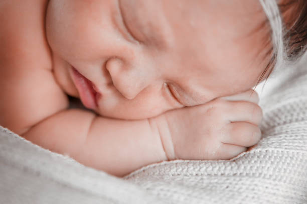 istock Newborn baby girl sleeping. 910222662