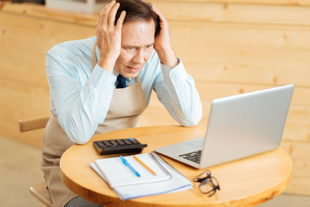 istock Sad disappointed entrepreneur sitting and looking at the screen 910225404