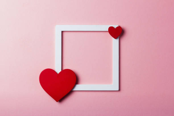 istock Frame with a heart on a pink isolated background 910225512