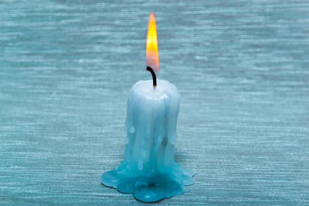 istock Ice candle burn and warm light on the ice wall background 910225628